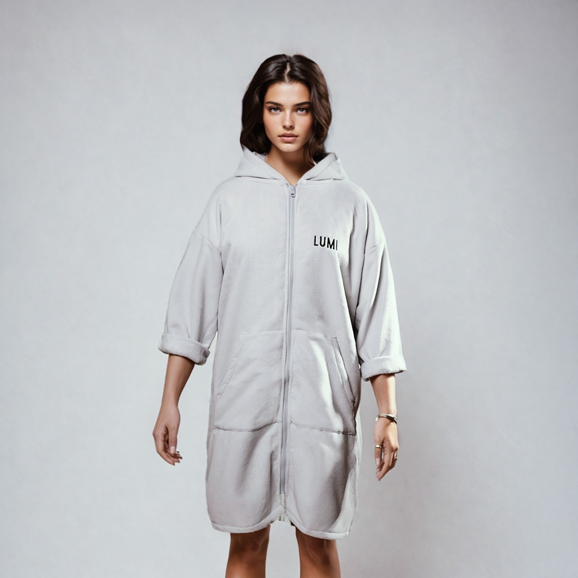 PRO DUO Changing Robe in Grey - Stylish hooded robe with LUMI branding, full-length zipper, and convenient front pockets shown against light background, featuring modern Nordic-inspired design and knee-length cut perfect for outdoor activities