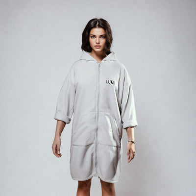 PRO DUO Changing Robe in Grey - Stylish hooded robe with LUMI branding, full-length zipper, and convenient front pockets shown against light background, featuring modern Nordic-inspired design and knee-length cut perfect for outdoor activities