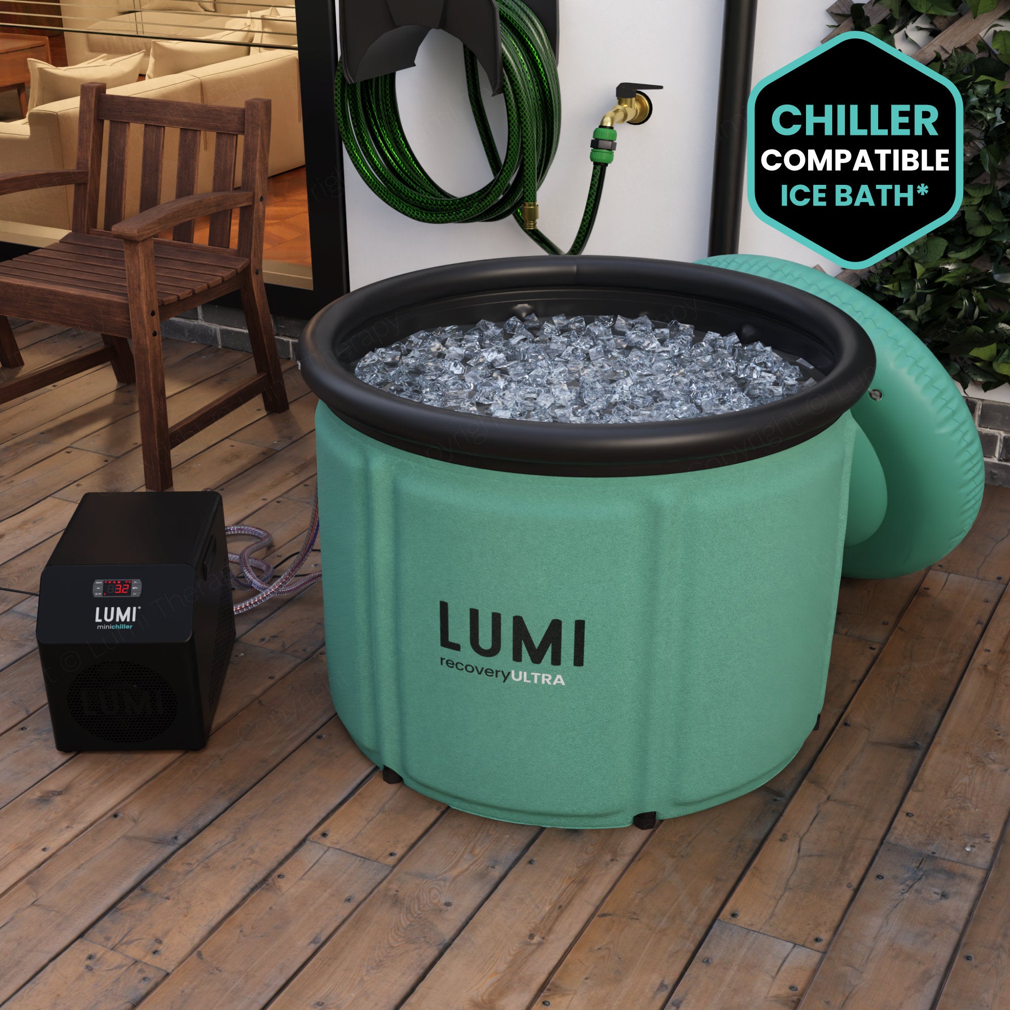 The Mint green LUMI Max Ultra ice bath, filled with ice in a garden setting.
