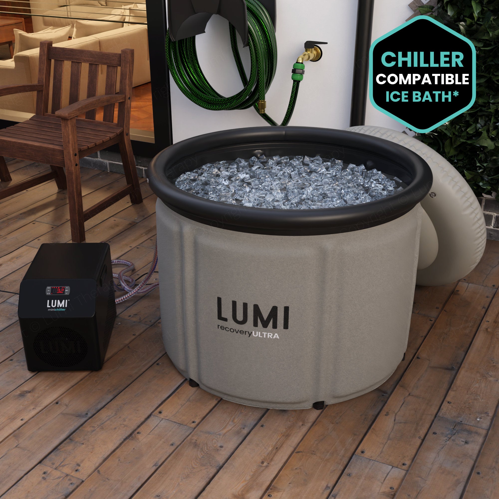 The Stone grey LUMI Max Ultra ice bath, filled with ice in a garden setting.
