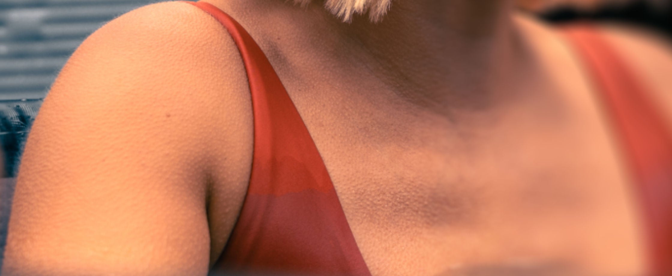 Close-up of a woman in a LUMI ice bath wearing an orange swimsuit