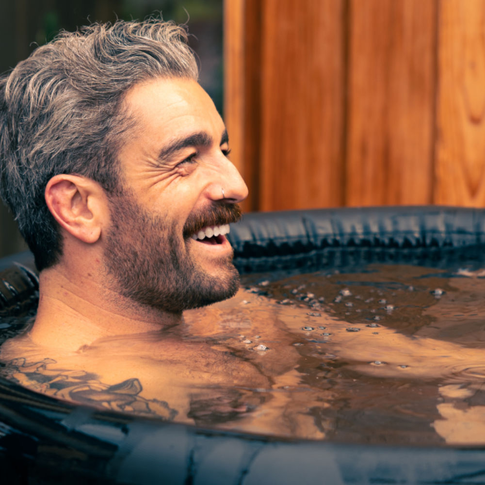 A man smiling whilst in a LUMI Pro 8 ice bath