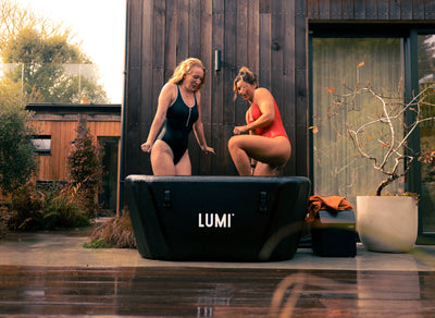 Two women stepping in the LUMI Pro Duo, in an outdoor setting.