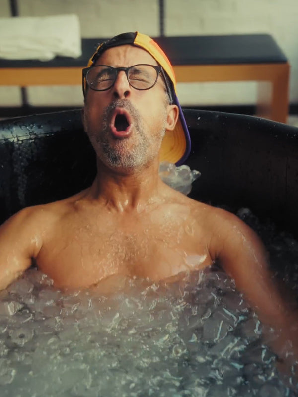 A man with a look of shock sat in a LUMI Pro Duo ice bath